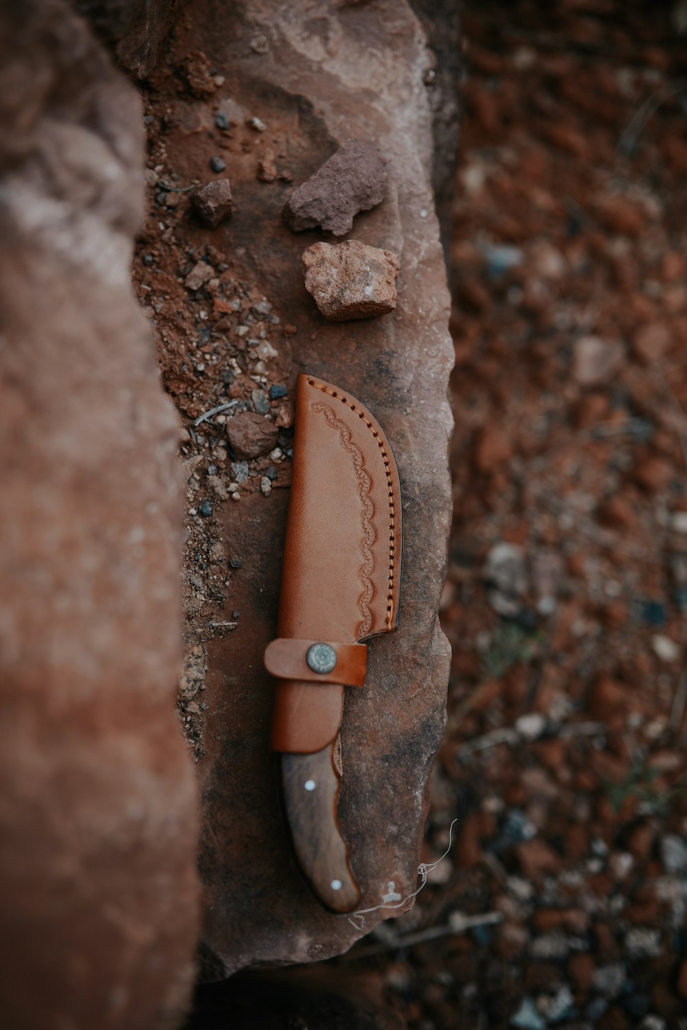 brown and silver knife on brown rock