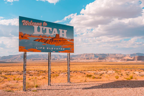 a welcome to utah sign in the desert