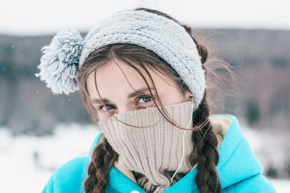 woman in white knit cap and brown jacket