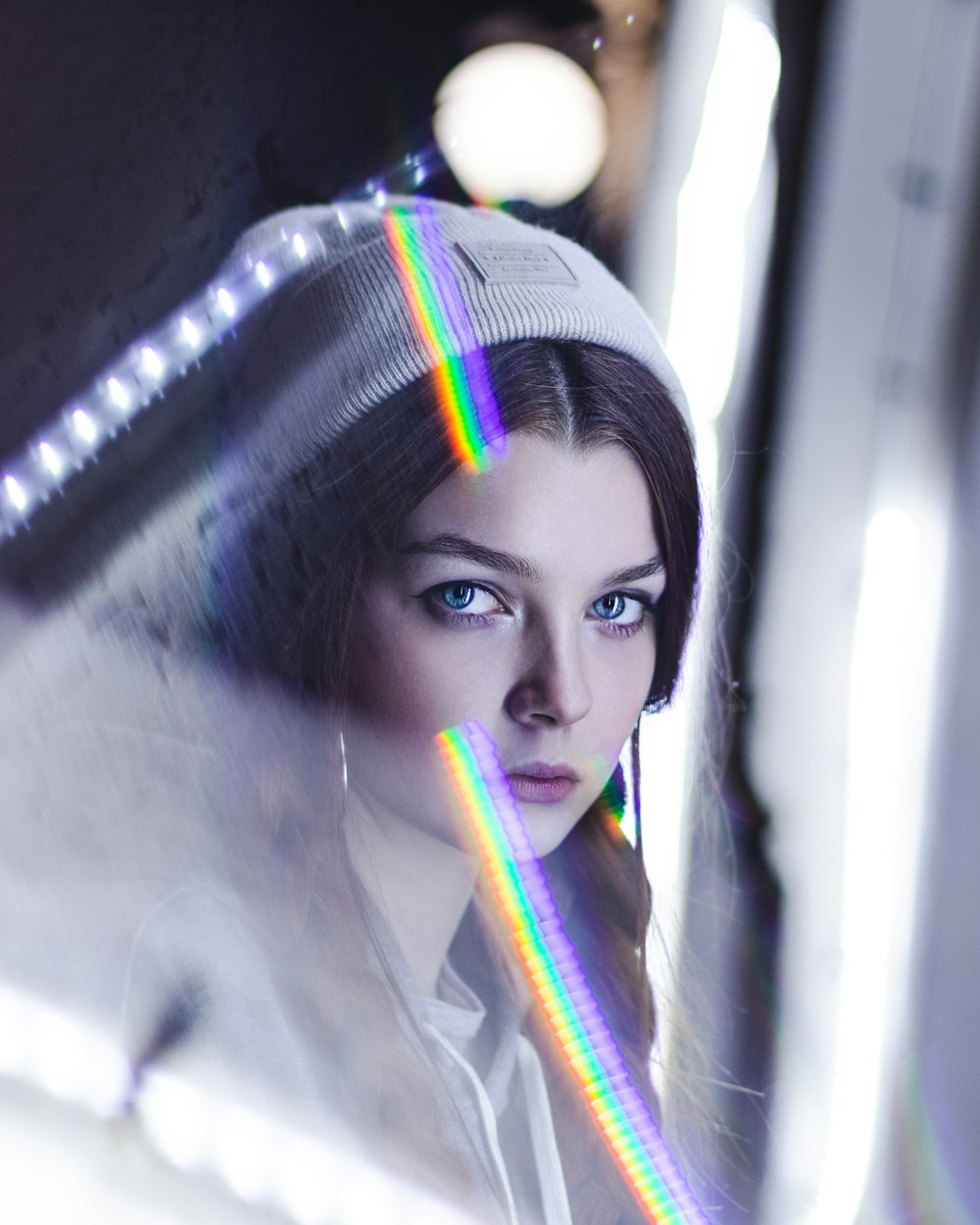 woman in white shirt with purple and blue hair tie