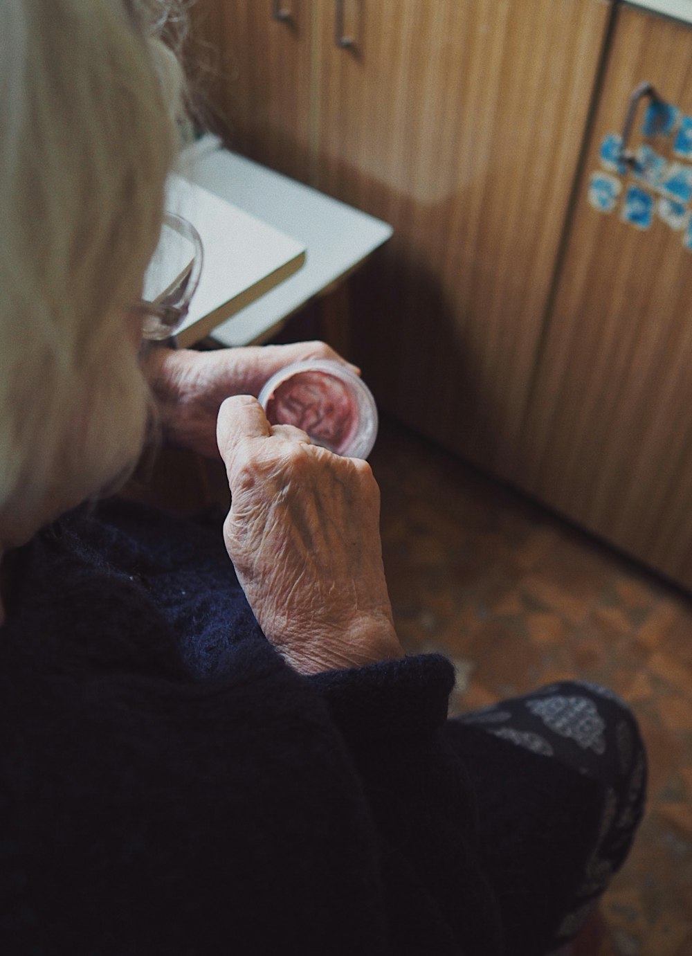 woman in black sweater holding white paper