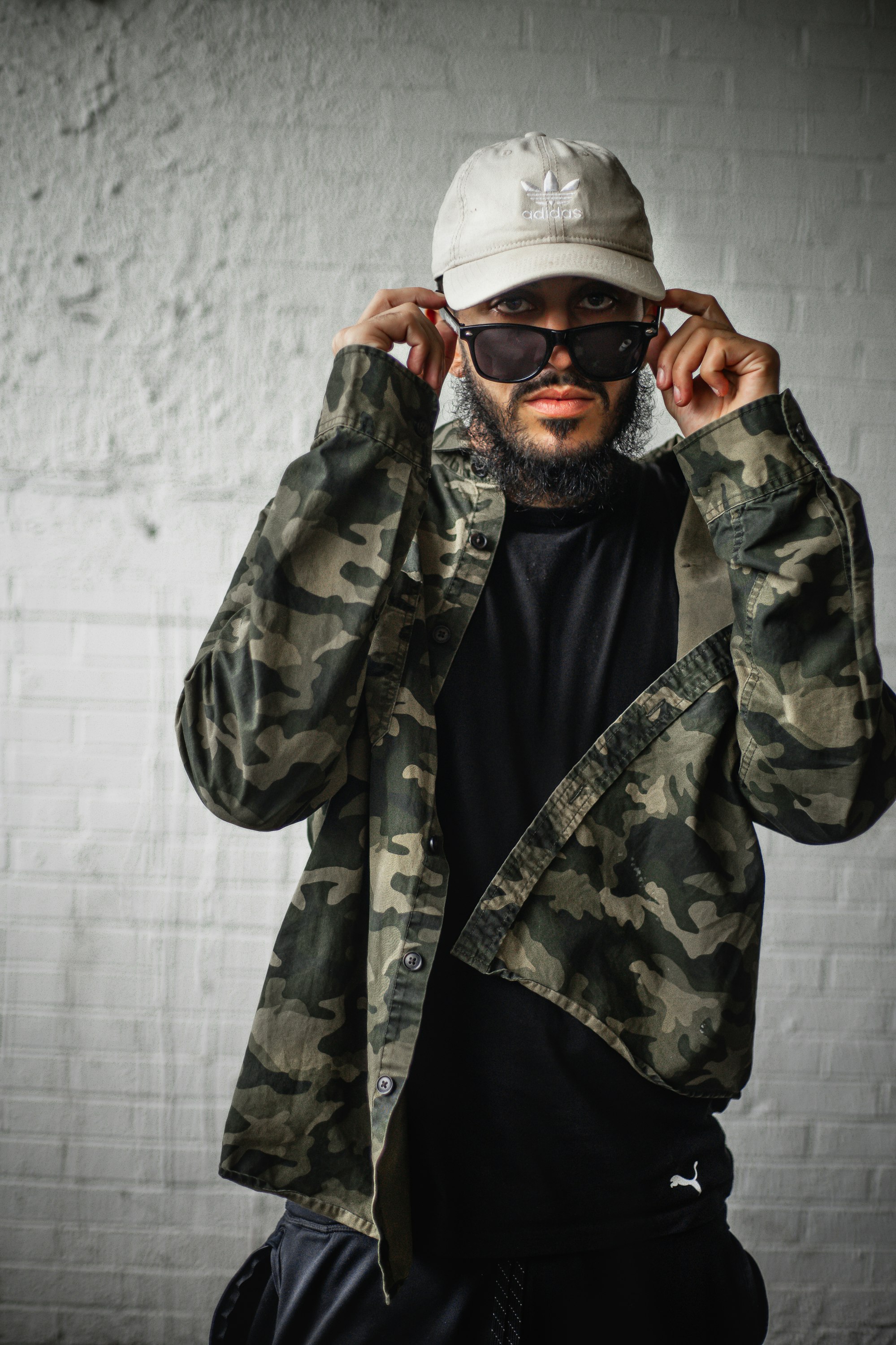 man in green and brown camouflage jacket wearing white goggles