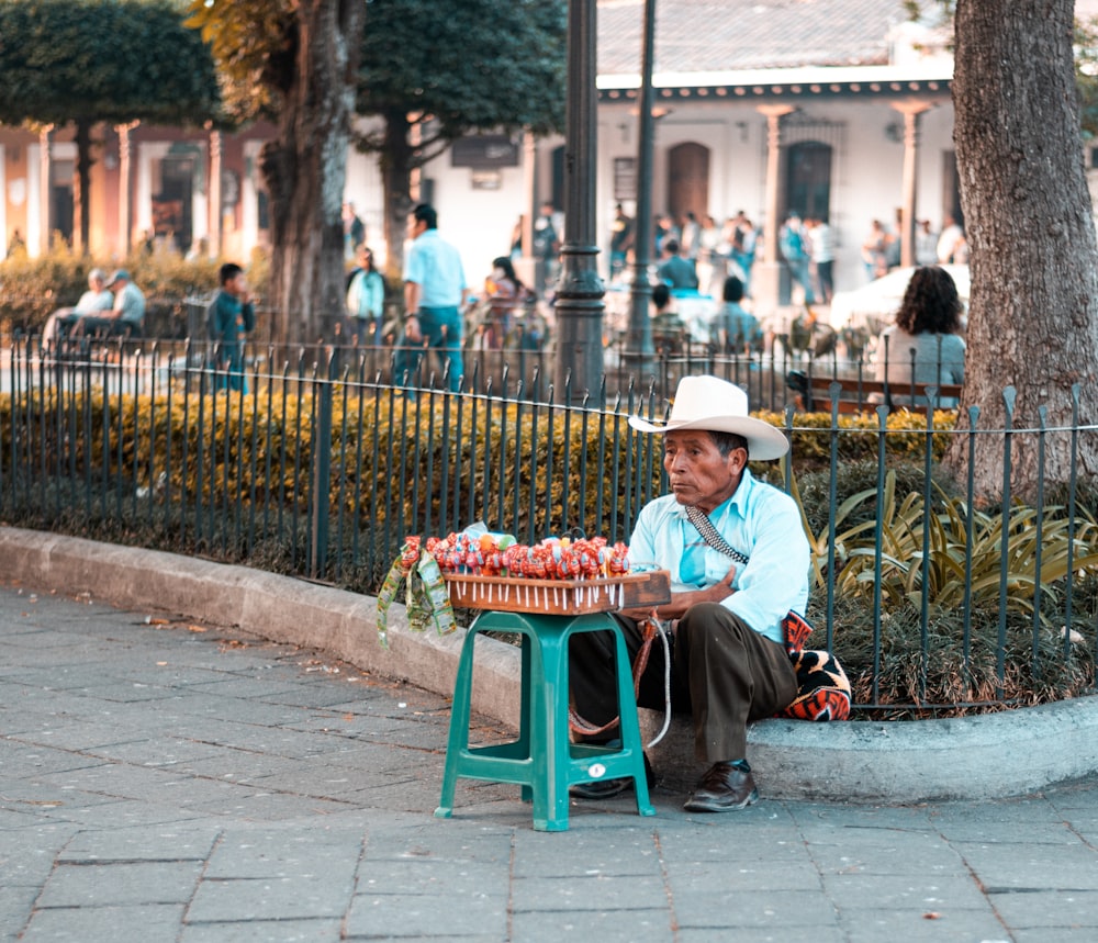 boy in red shirt sitting on green chair