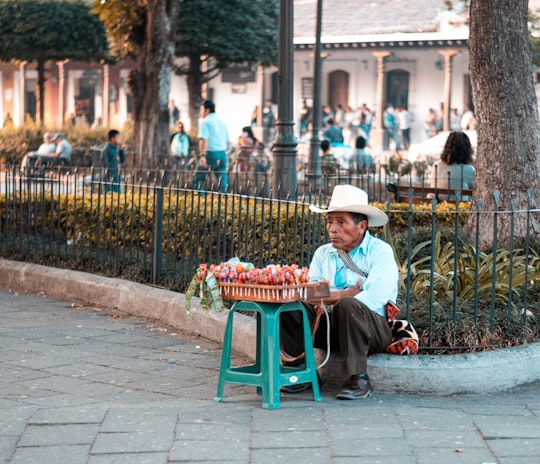 boy in red shirt sitting on green chair in Antigua Guatemala Guatemala