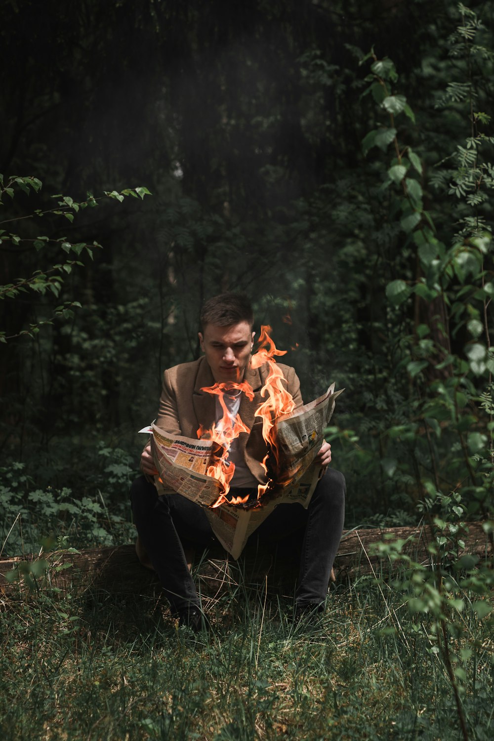 man in orange long sleeve shirt sitting on brown wooden chair