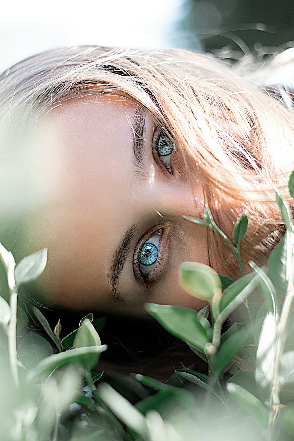 womans face covered with white flowers