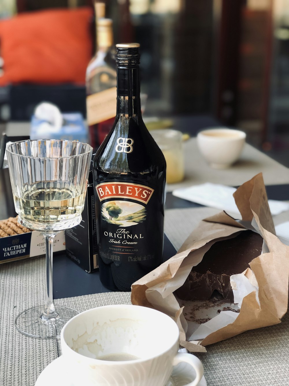 black and white labeled bottle beside clear wine glass