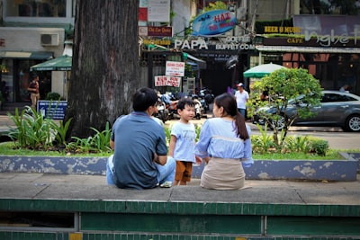 people sitting on bench near road during daytime comic con zoom background