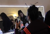 A happy client admiring their new hairstyle in the mirror.