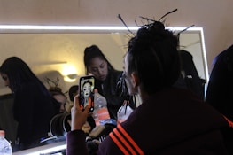 A happy client admiring their new hairstyle in the mirror.