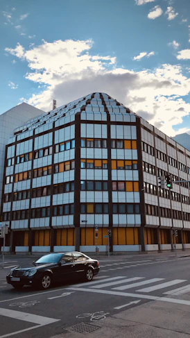 A modern commercial building with Dorothea reviewing plans on site