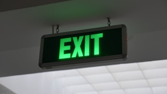 Fire safety equipment and emergency exit signs in a commercial building.