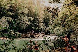 Family enjoying a peaceful afternoon by the nearby Liucura river surrounded by lush forest