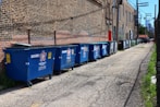 blue trash bins on gray concrete floor