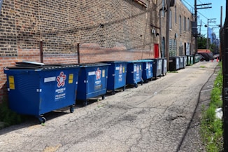 blue trash bins on gray concrete floor