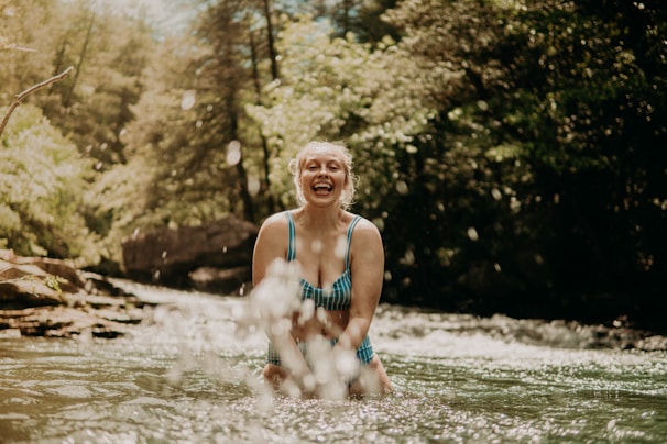 A refreshing cold plunge moment captured with clear blue water and smiling participants outdoors.