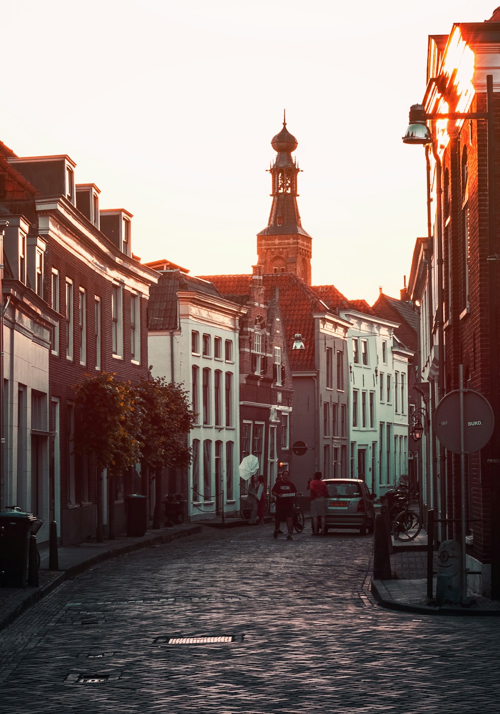 people walking on street between buildings during daytime