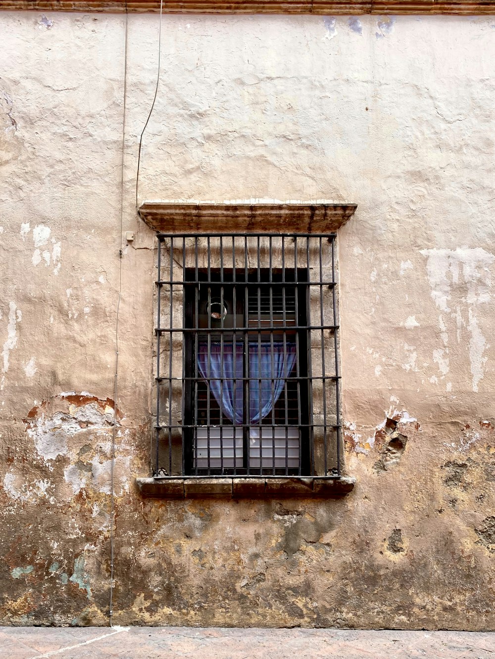 blue metal window frame on brown concrete wall