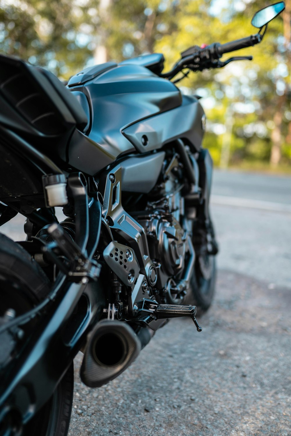 blue and black motorcycle on road during daytime