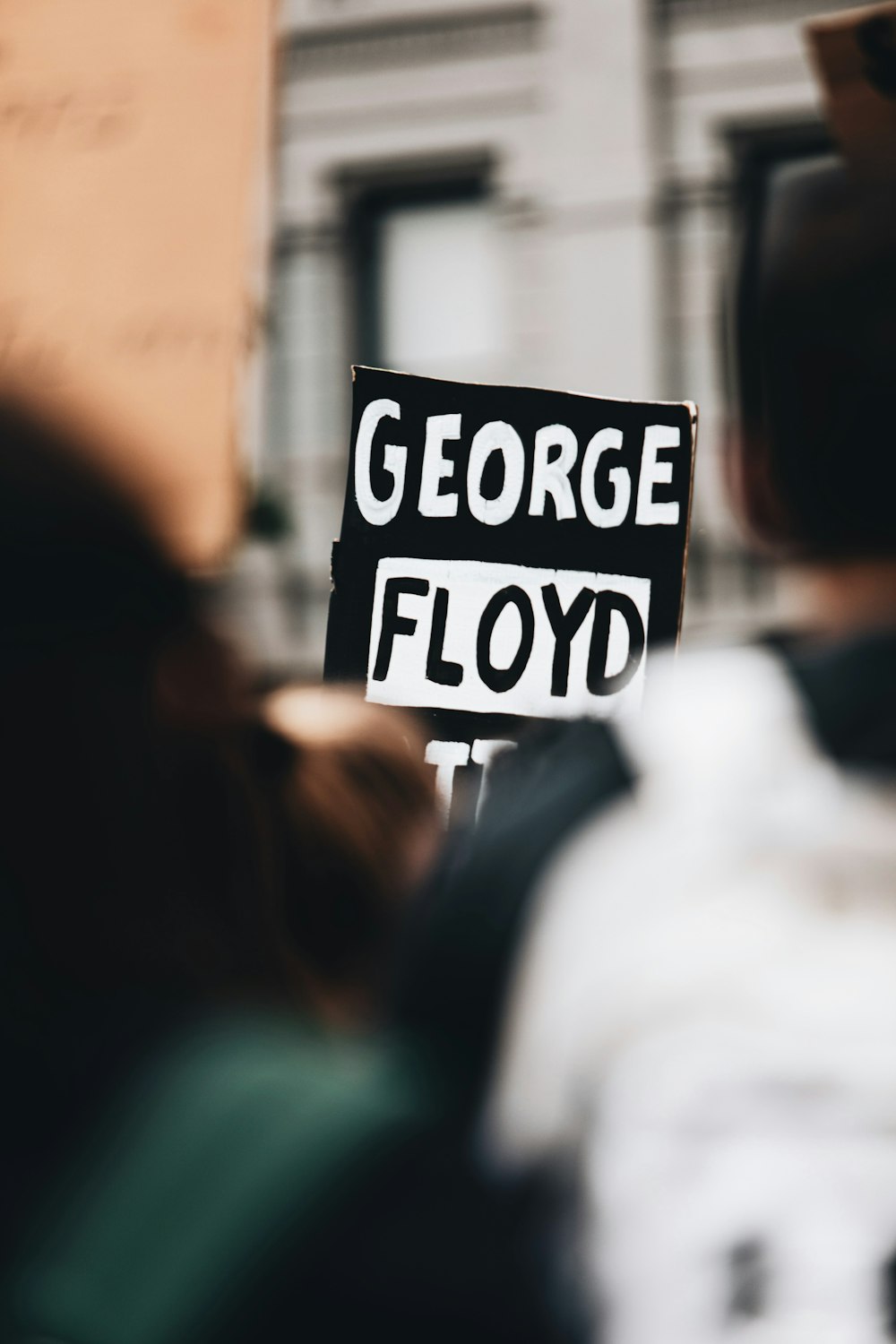 person holding white and black stop sign