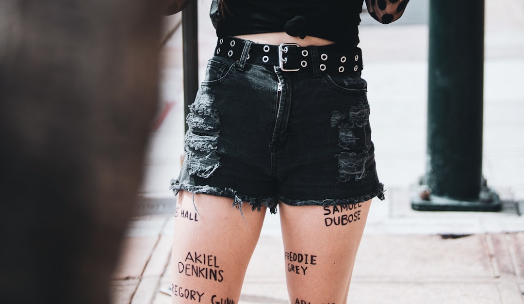 woman in black crop top and blue denim shorts