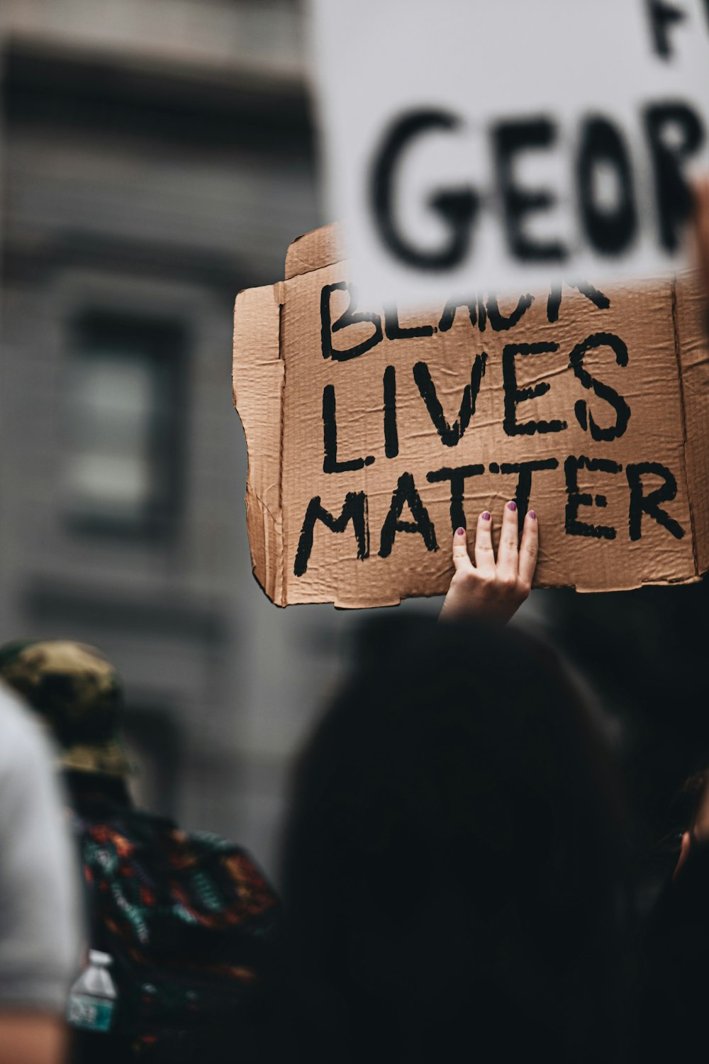 a person holding a sign that says blood lives matter