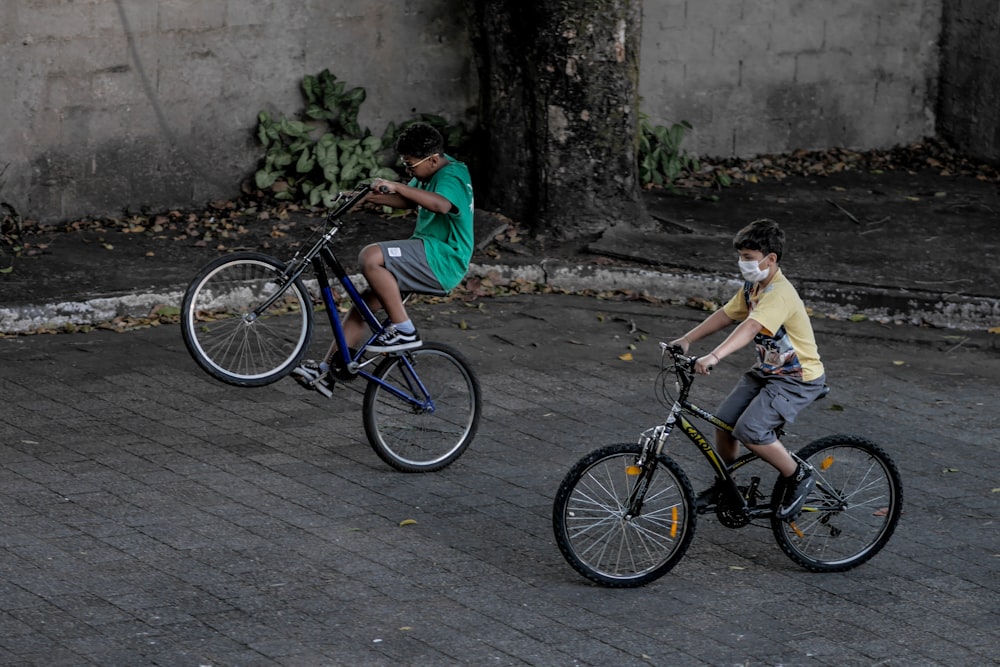 man in green shirt riding on black bicycle