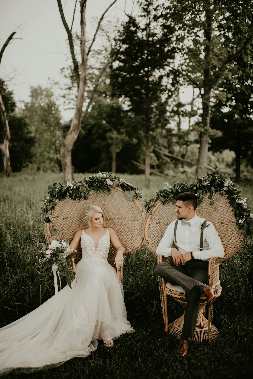 man and woman sitting on brown wooden chair