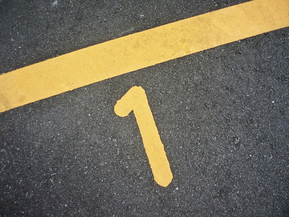 yellow letter b on gray asphalt road