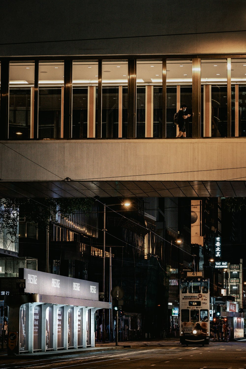 people walking on sidewalk near building during night time