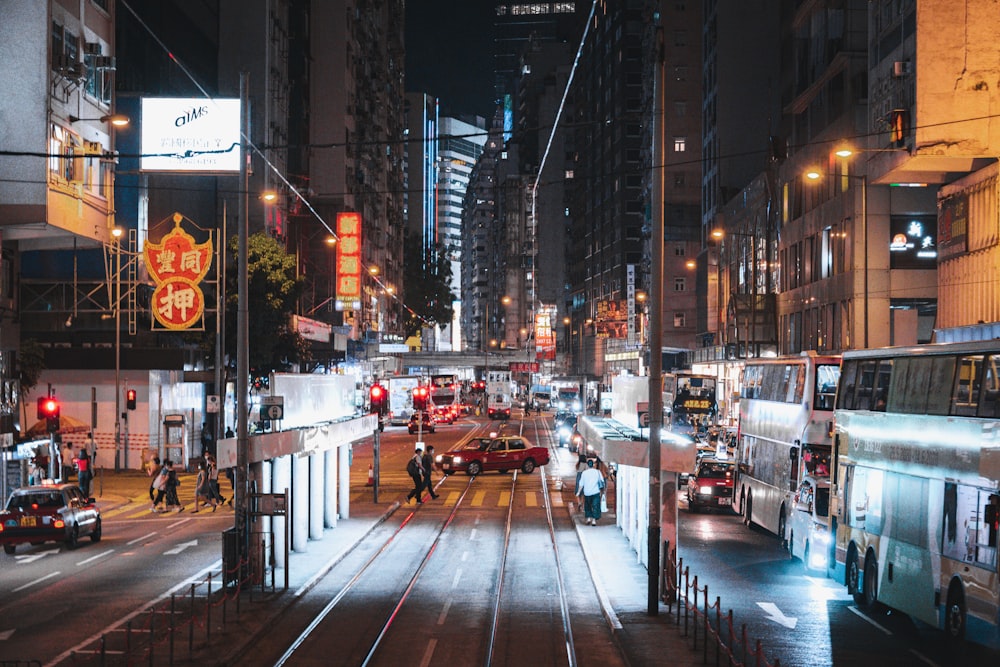 people walking on sidewalk during night time