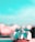 A close-up of a toy race car is positioned on a flat surface with a blurred background. The toy has a sleek, aerodynamic design with a predominantly white body and red accents. The sky above is bright and clear, with a pronounced turquoise hue that enhances the toy's vibrant details.