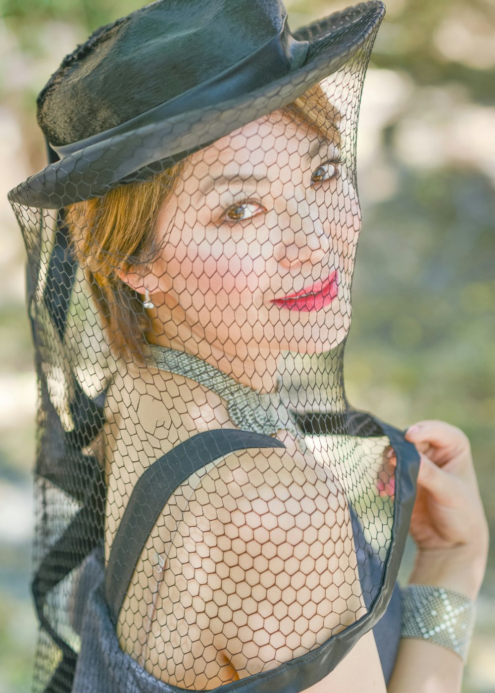 woman in black and white tank top wearing black hat