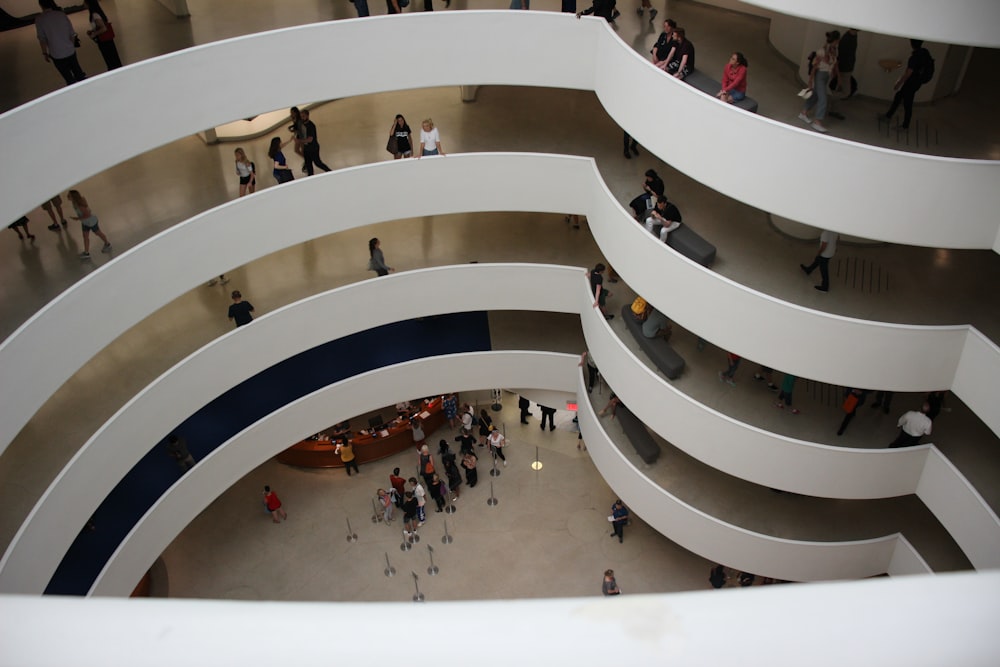 people walking on white spiral staircase
