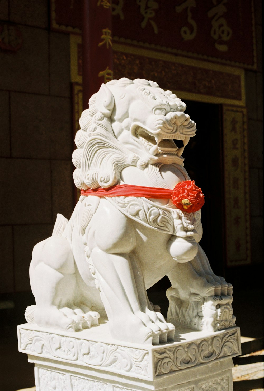 white and red angel holding red rose figurine