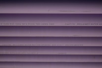 Several purple PVC pipes with black text printed on them. The text includes specifications and a caution that the water is not for drinking.
