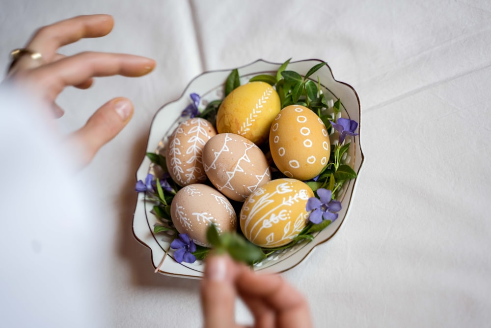 six brown eggs on blue and green floral ceramic plate