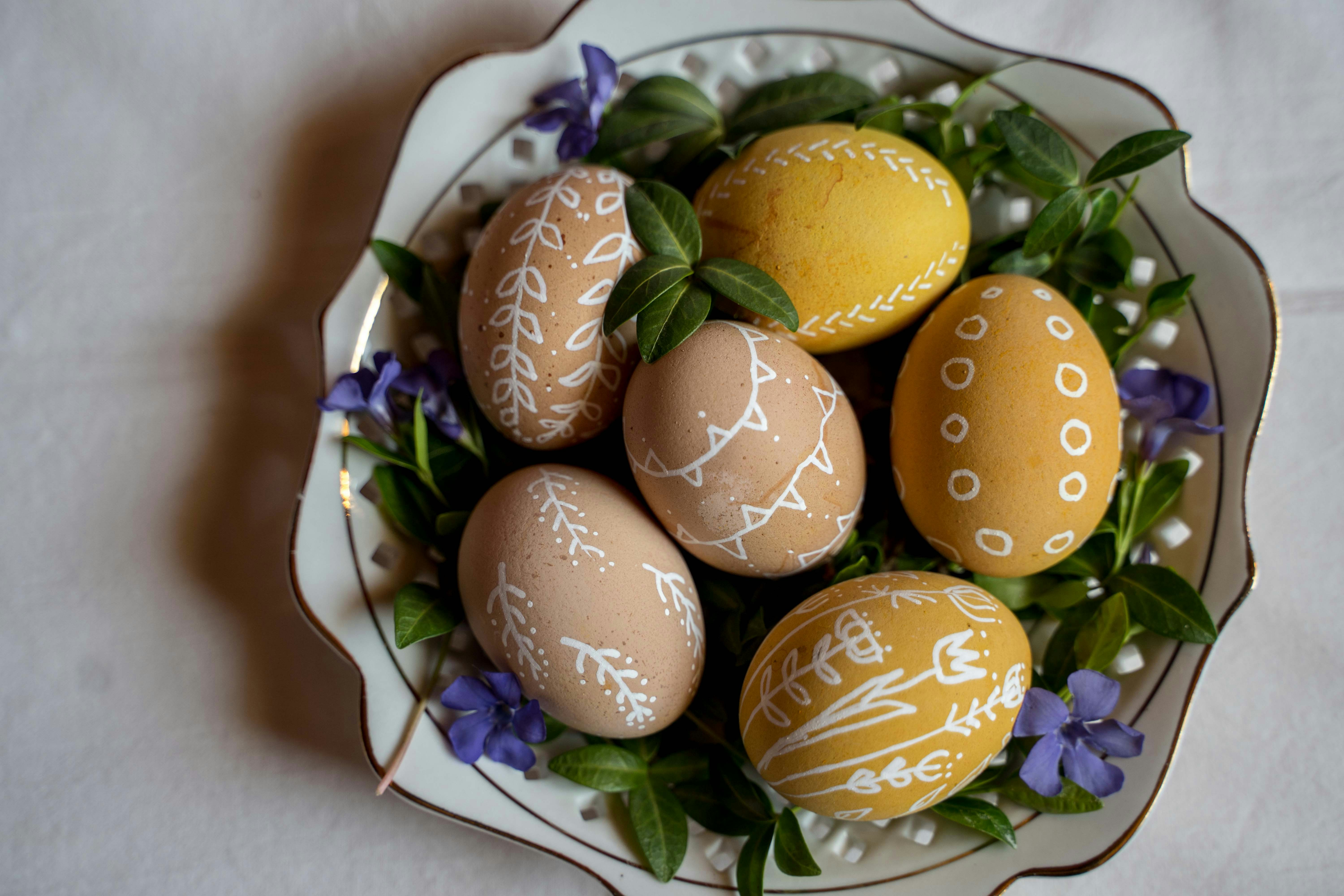 three brown eggs on white ceramic plate easter egg teams background