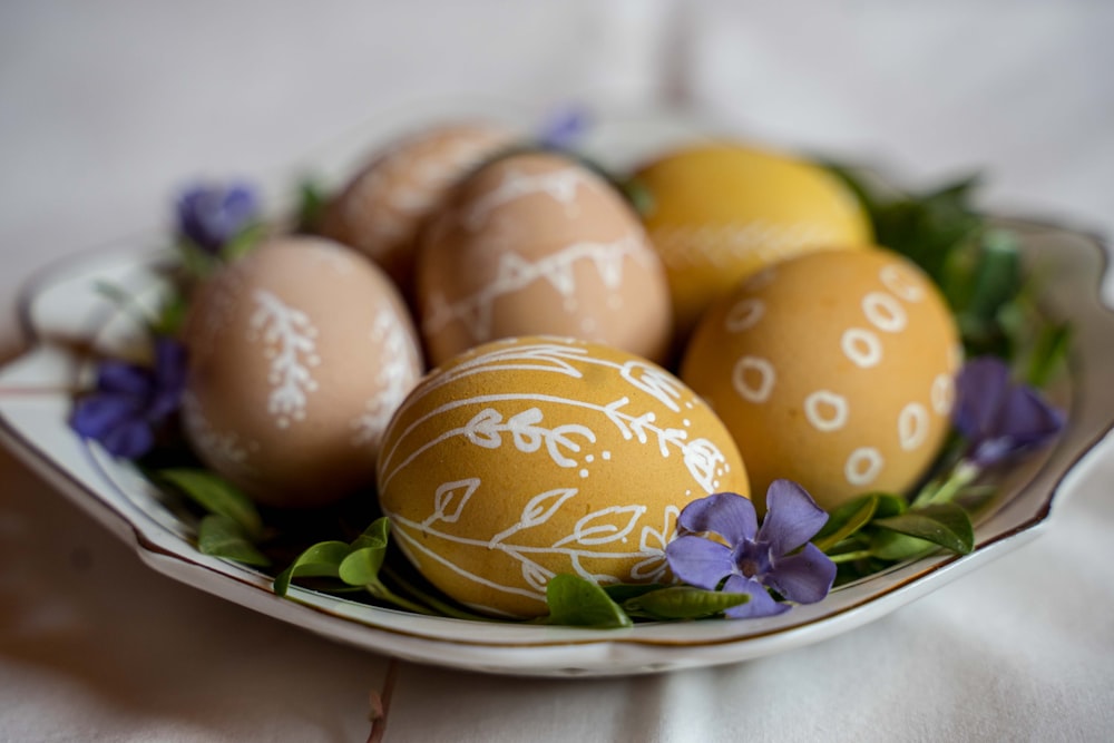 yellow and purple egg on green and white floral ceramic plate