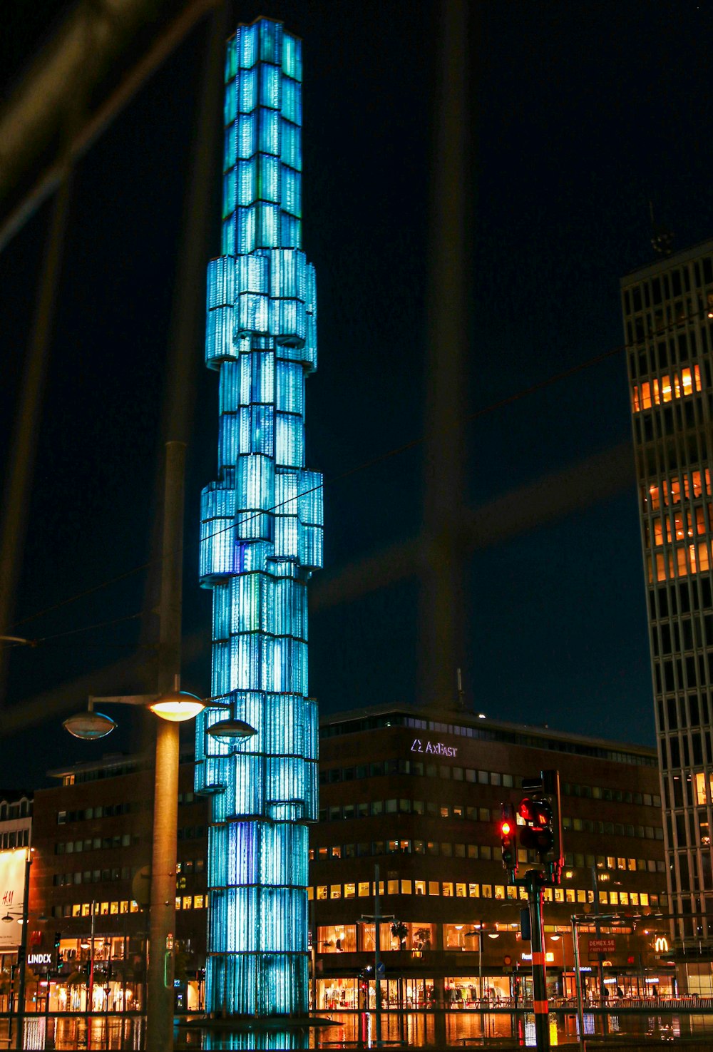 blue and white high rise building during nighttime