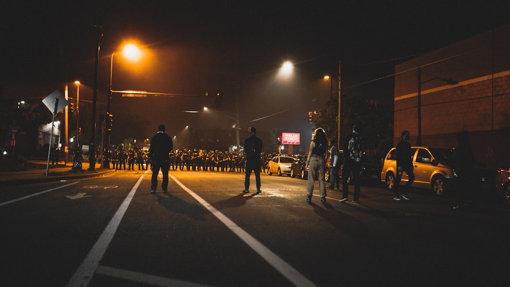 people walking on street during night time