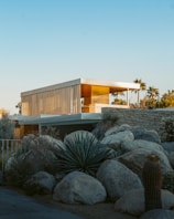 brown wooden house near green trees during daytime