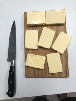 black handled knife beside cheese