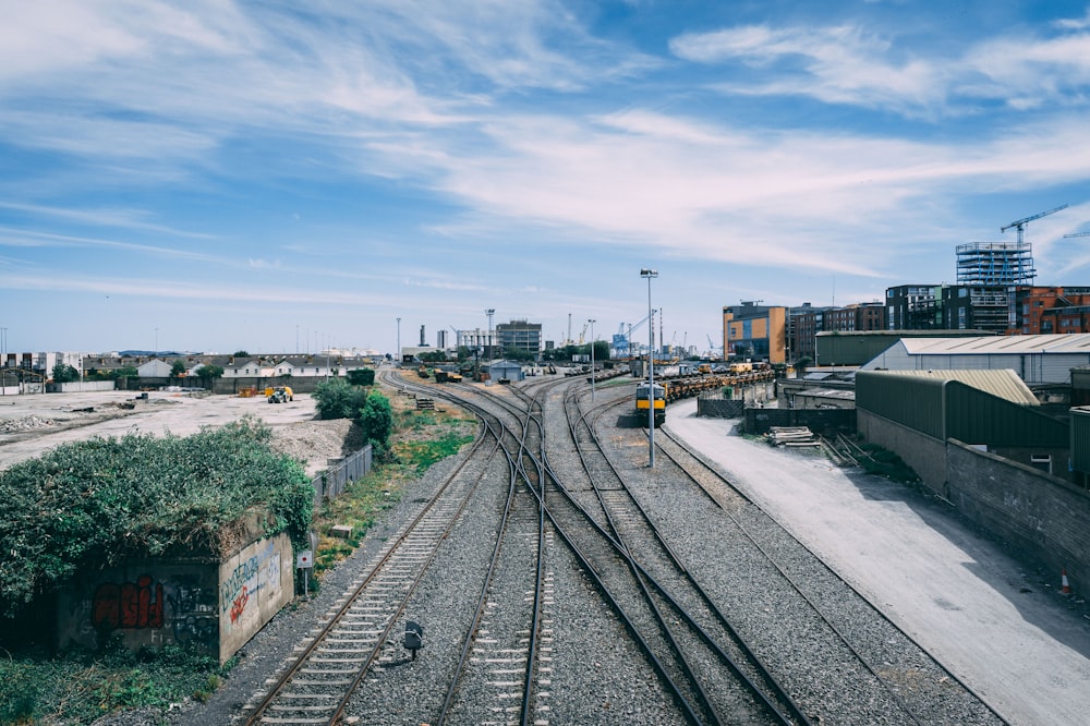 a view of a train track with buildings in the background