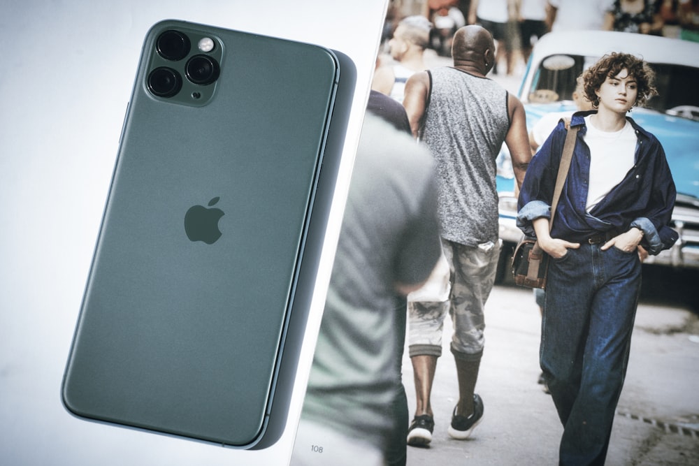 a picture of a man walking down a street next to a cell phone