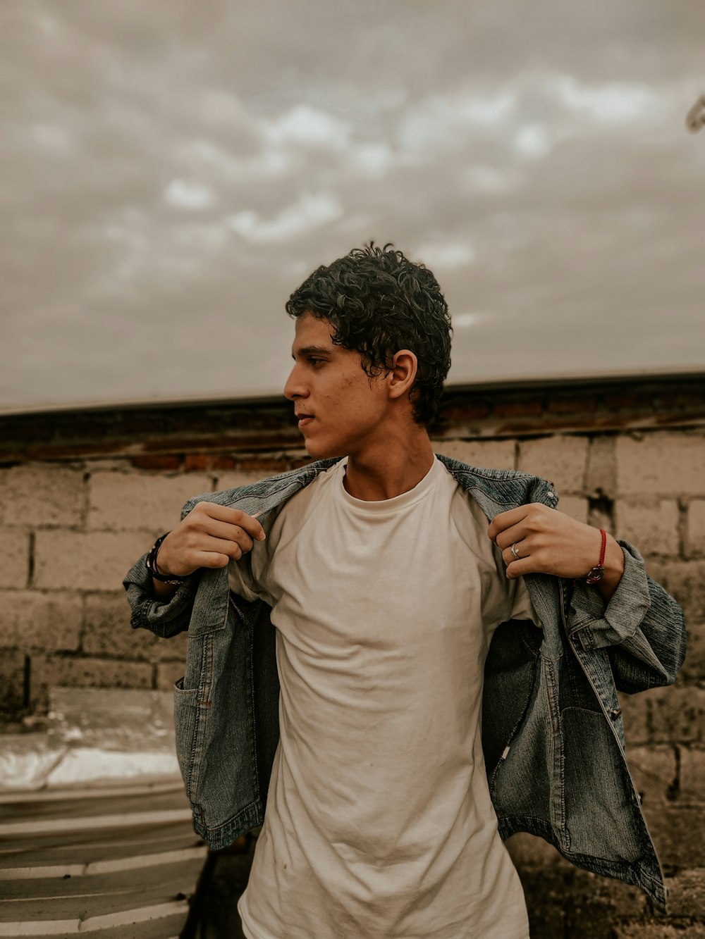 man in white crew neck shirt and gray scarf