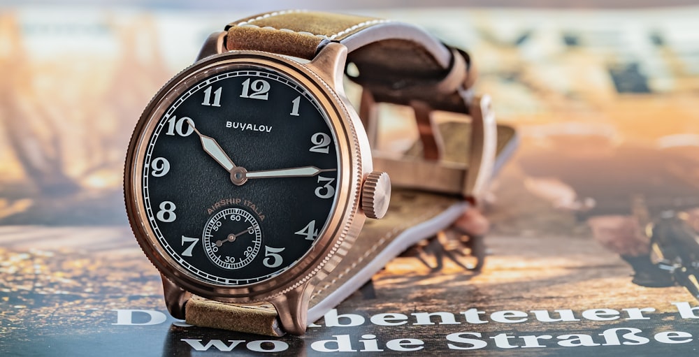 brown wooden analog watch at 10 10