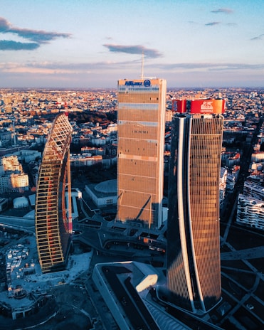 Aerial view of a modern city skyline at sunset.