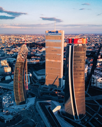 A sleek aerial view of Miami's bustling commercial district at sunset, highlighting modern skyscrapers and waterfront.