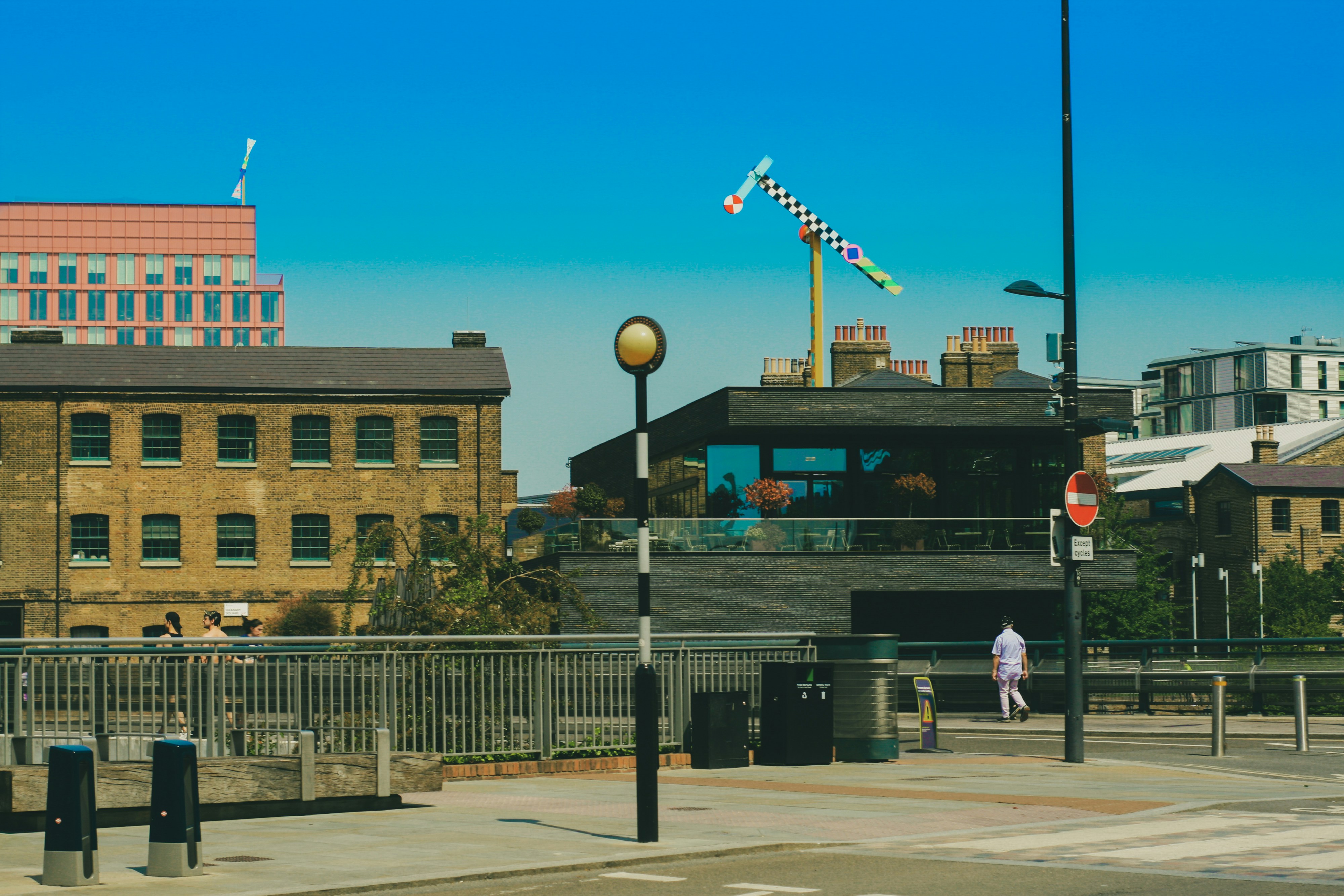 people walking on sidewalk near brown building during daytime